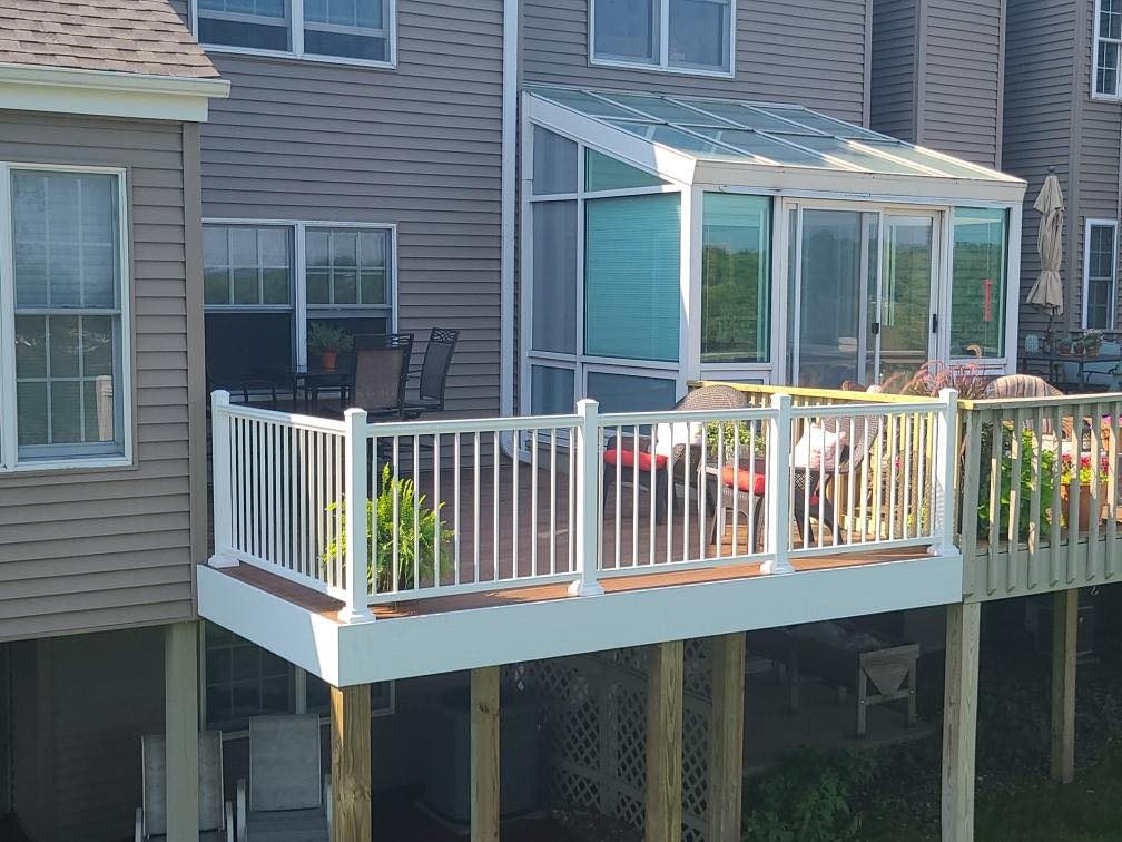 Sunroom and elevated deck with white railing