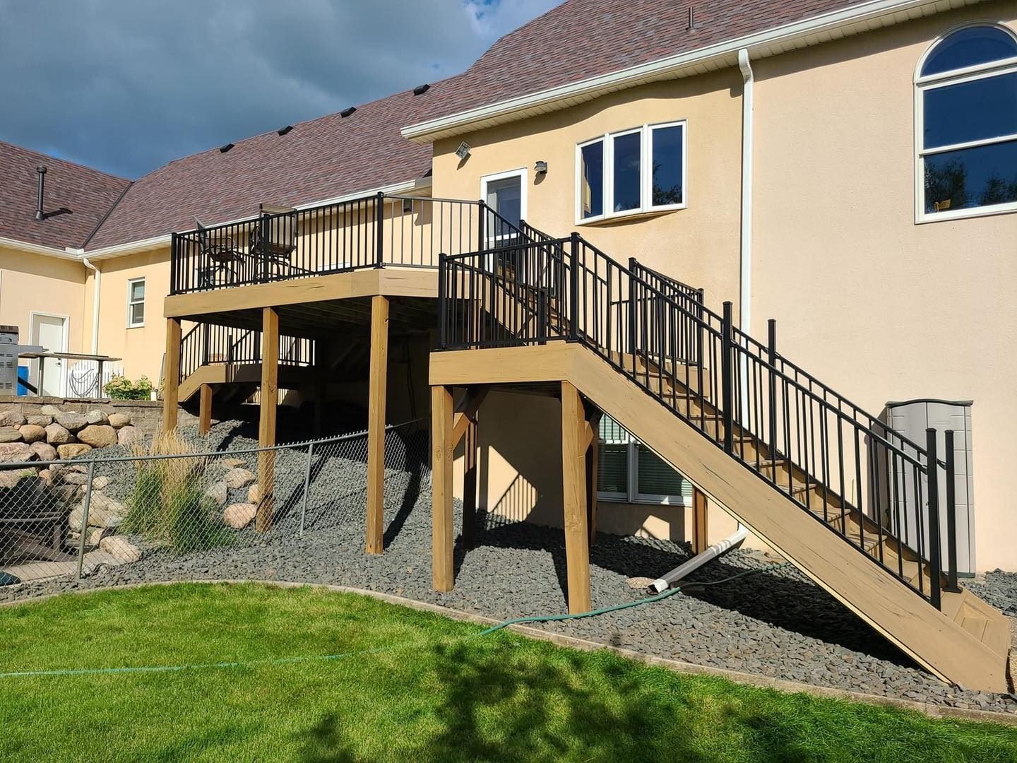 Elevated deck with stairs on a stucco home