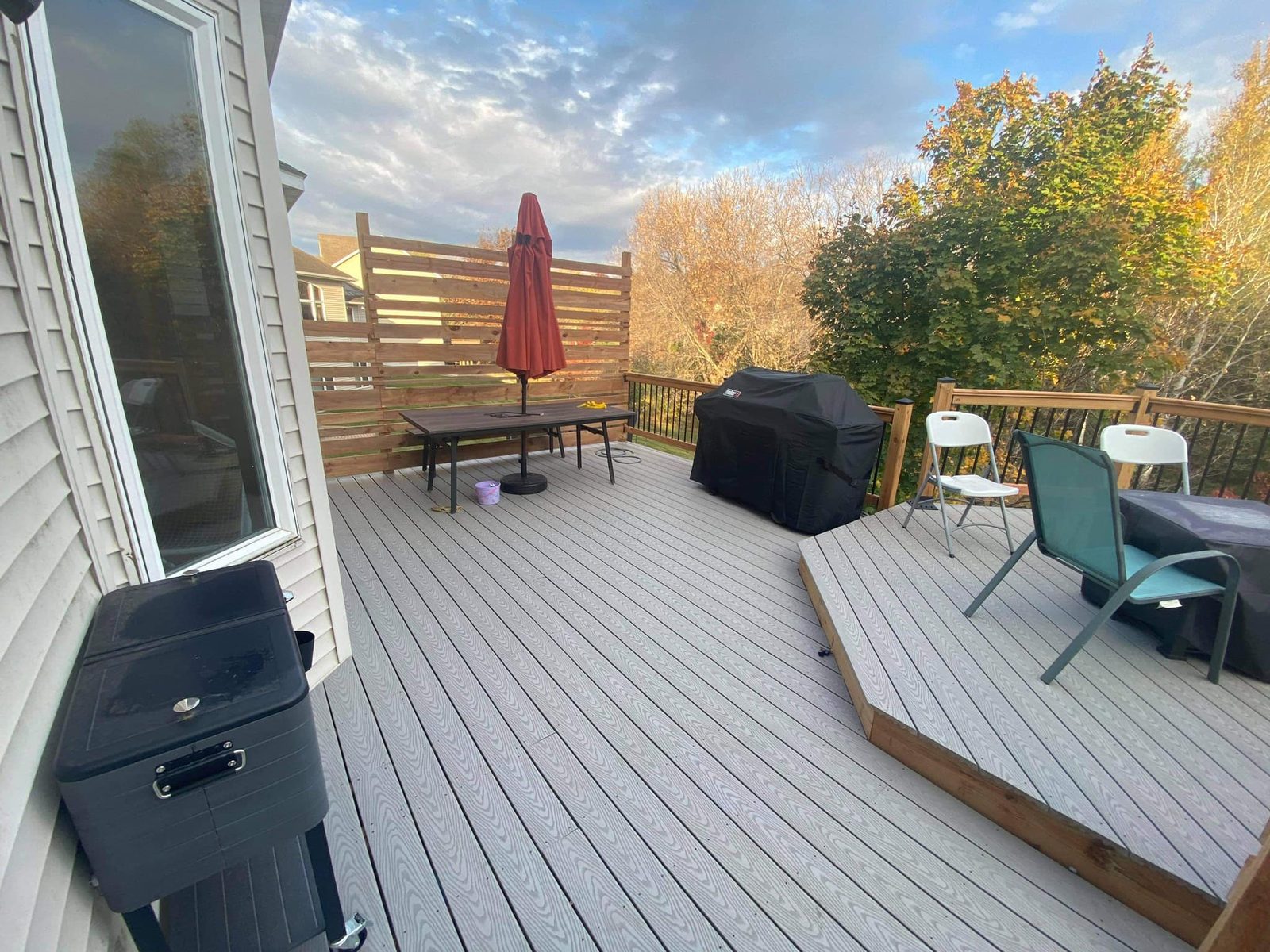 Gray composite deck with a cedar privacy screen