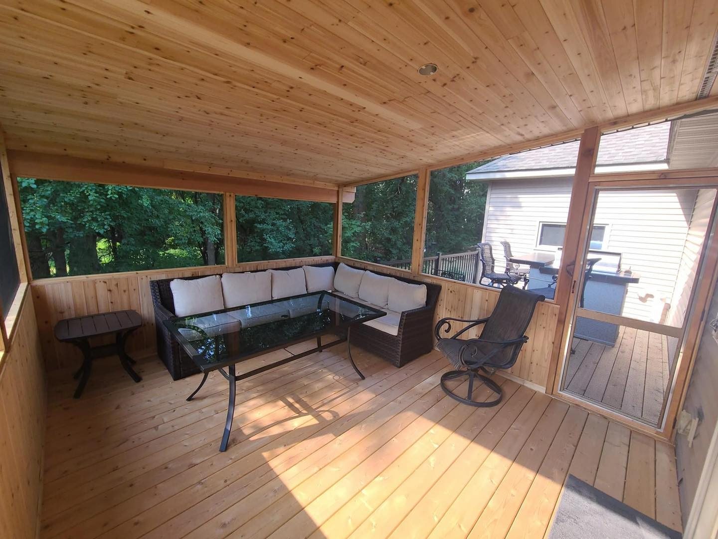 Screened porch interior with cedar ceiling and floor