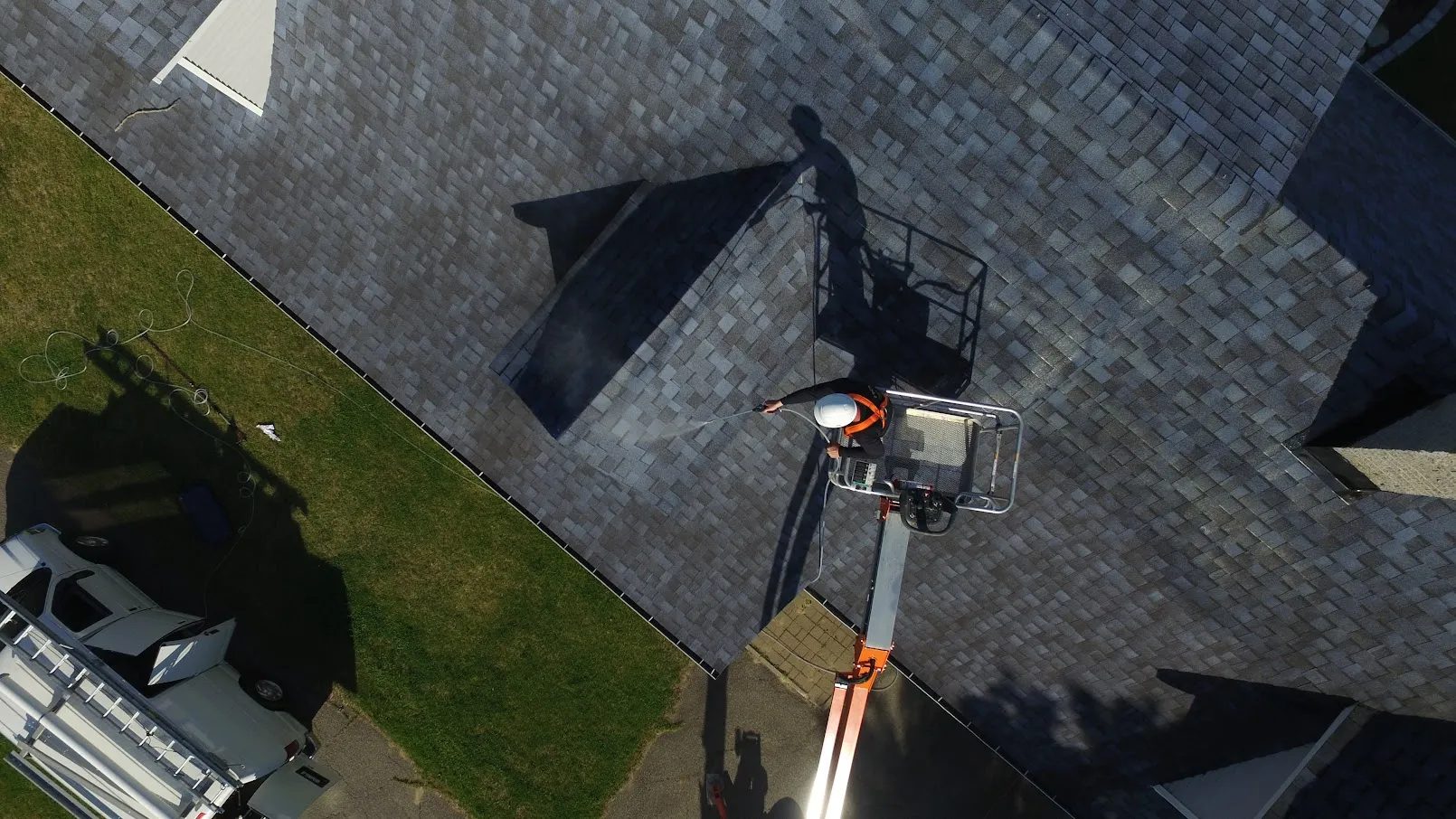 Technician applying GoNano to a shingle roof