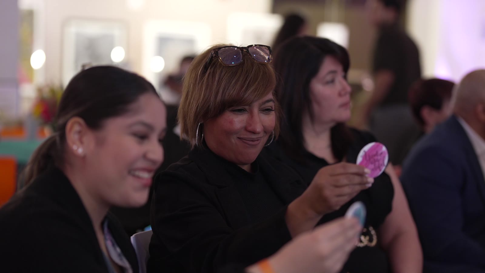 Three women laughing together during the 2026 Inspírame Latina Summit