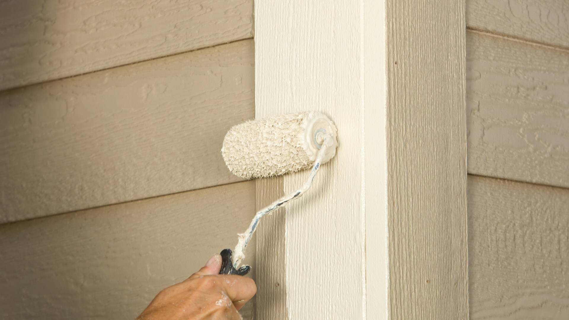 exterior trim board receiving protective clear coat in Largo home