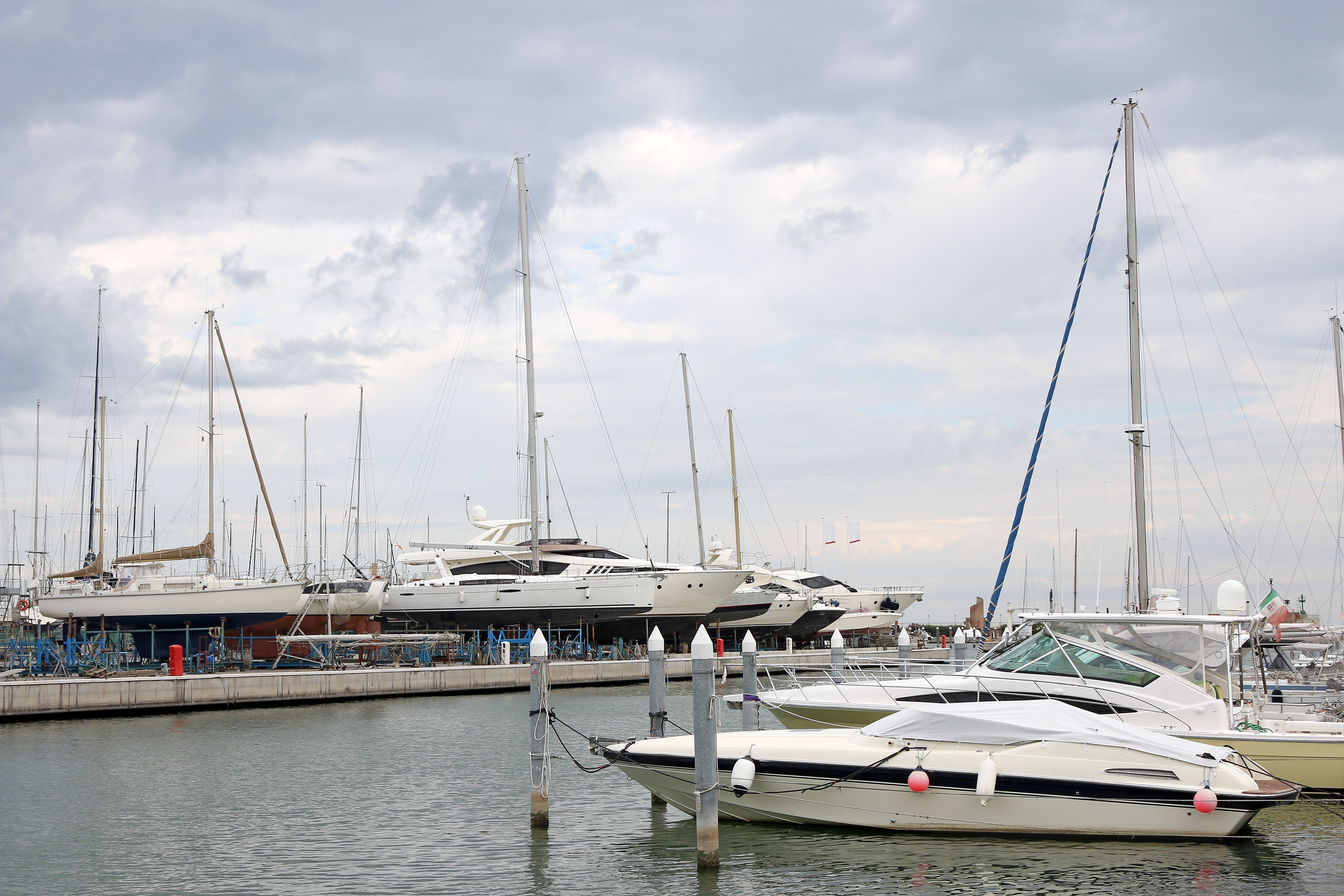 Motor yachts and sailboats moored at a marina