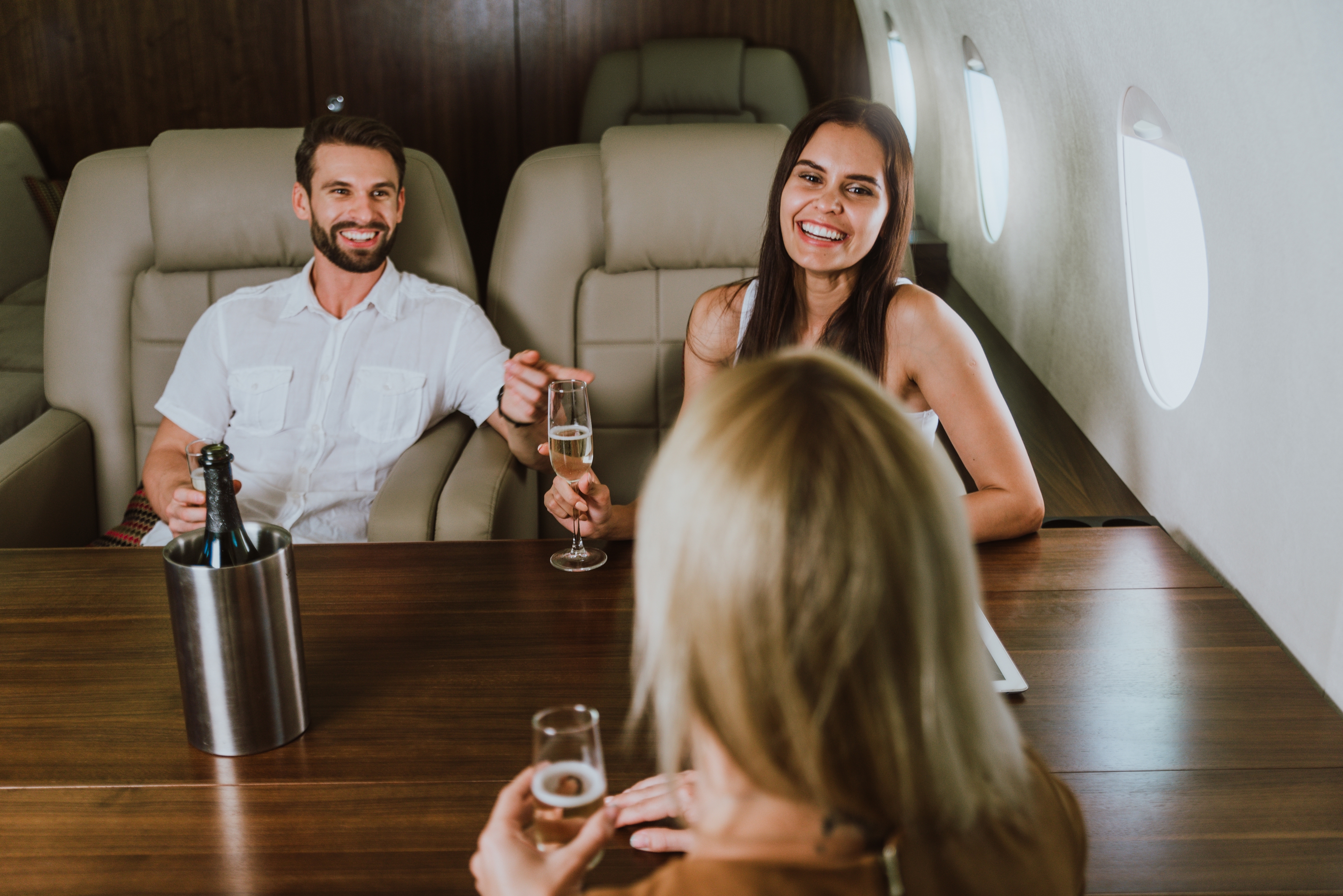 Passengers relaxing together inside a private jet cabin