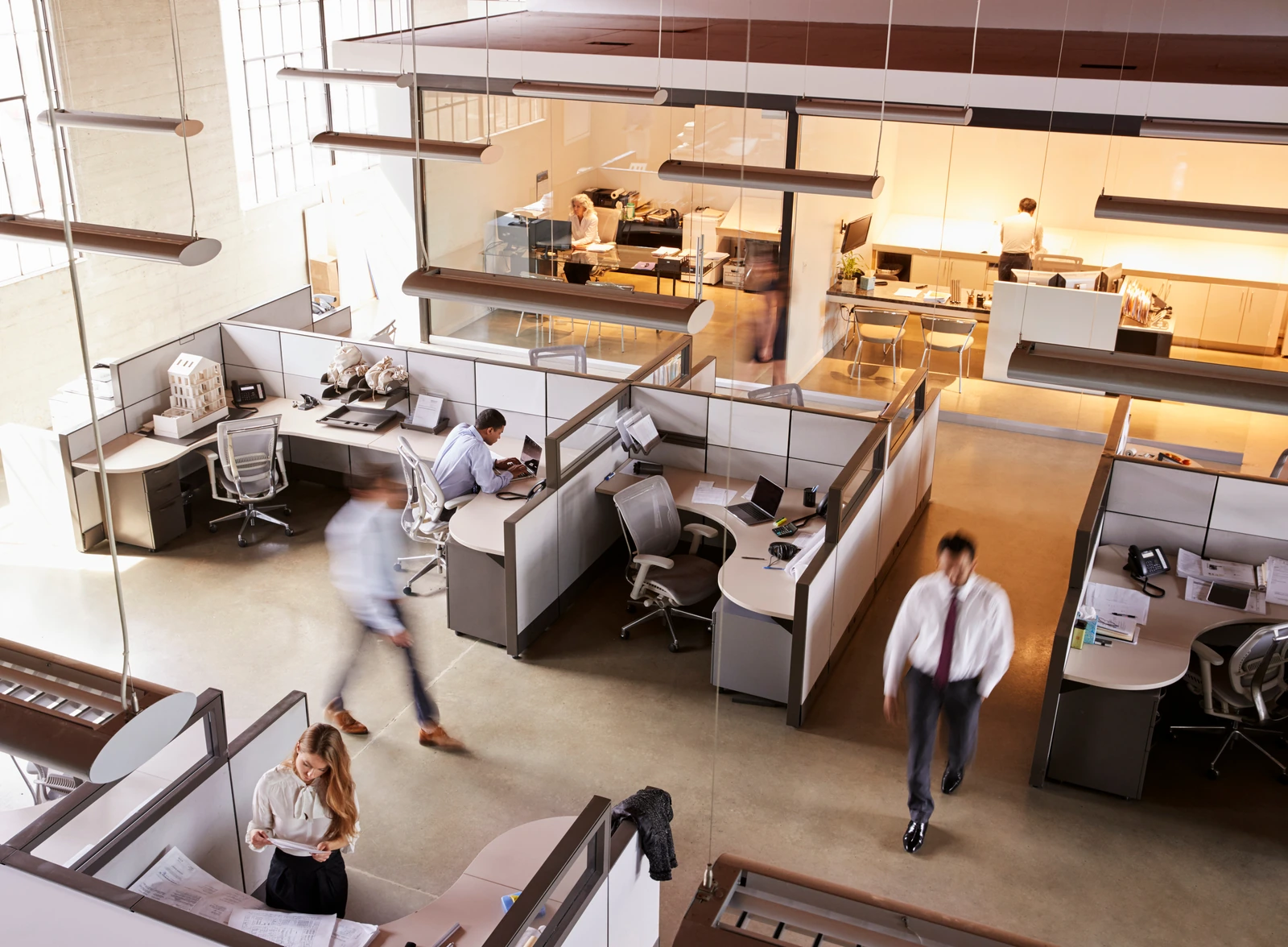 An elevated view of colleagues working in the same open-plan office shown elsewhere on the site.