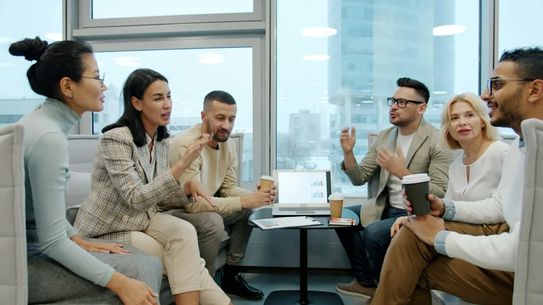Business owners and colleagues discussing ideas in a bright meeting space