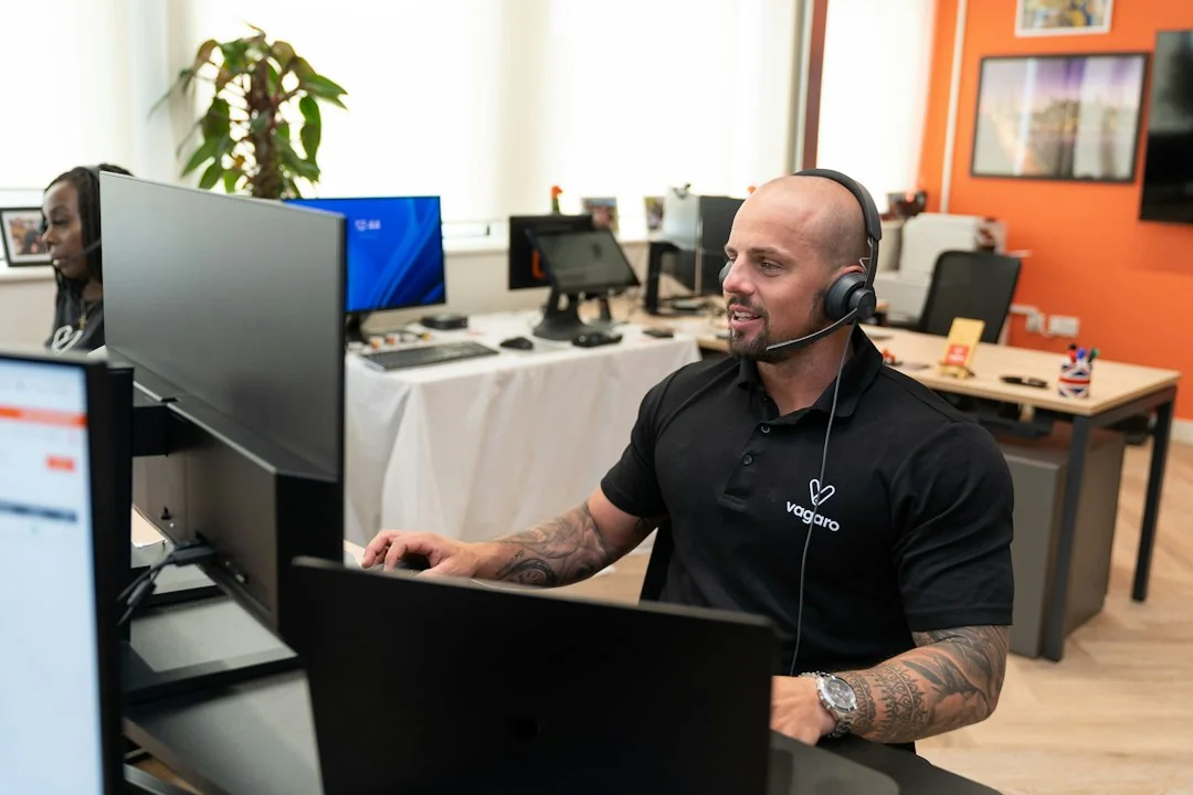 A business team member handling a customer conversation at a computer