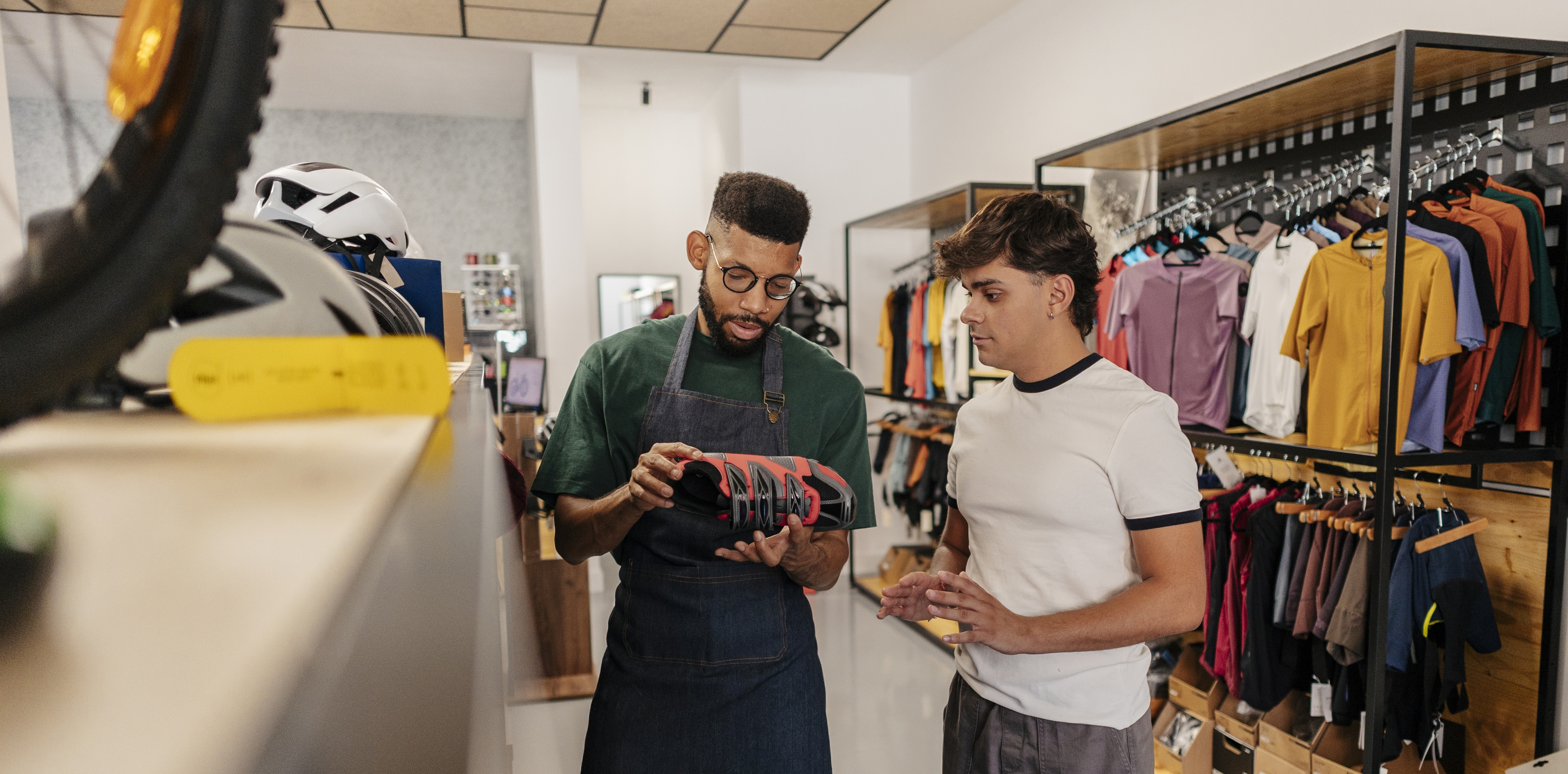 Retail specialist helping a customer choose sports equipment
