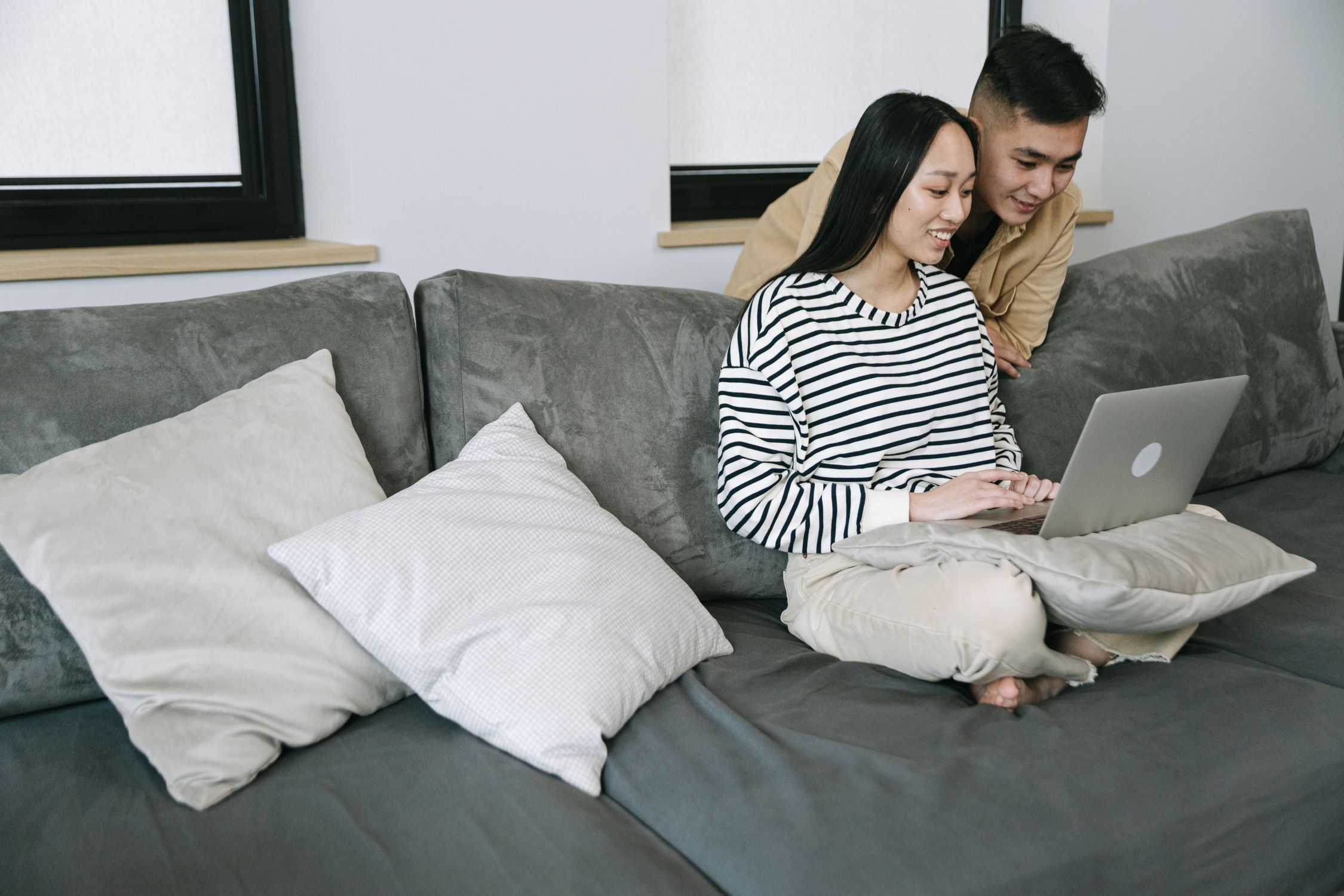 A couple browsing together on a laptop at home