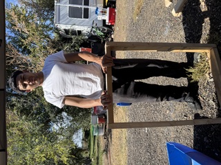 Young participant handling farm equipment at Blooming Health Farms