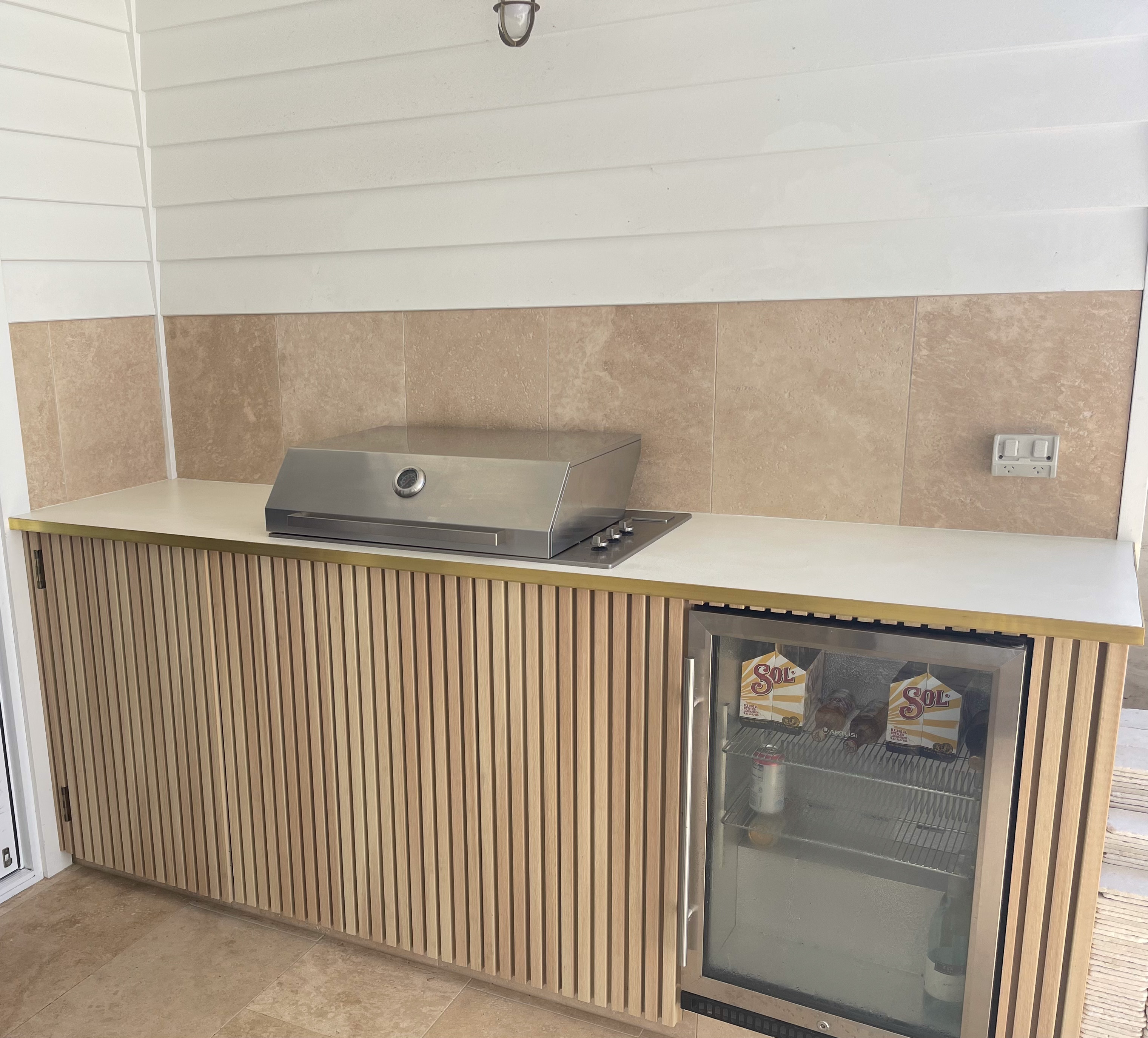 Outdoor kitchen with coated cabinetry