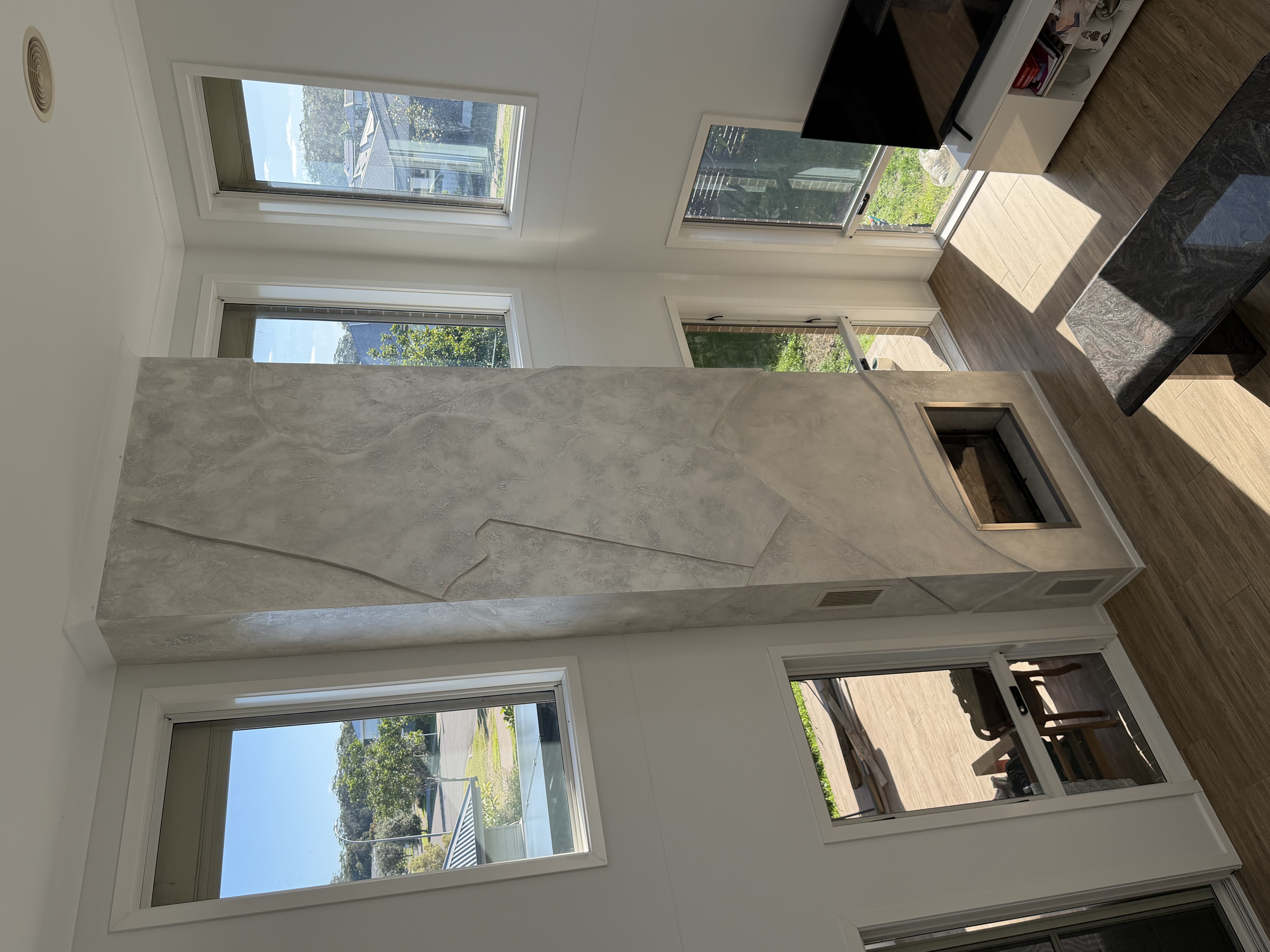 Venetian plaster two-storey fireplace feature