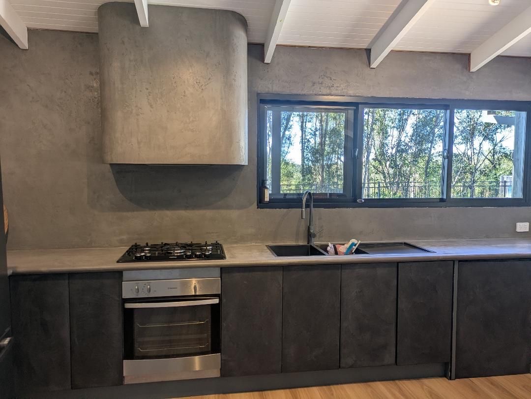 Microcement kitchen with seamless benchtop and rangehood