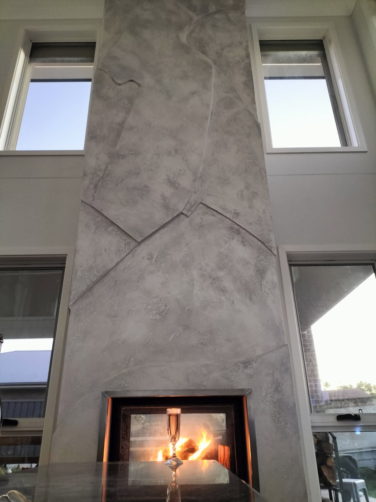 Venetian plaster fireplace with lit fire