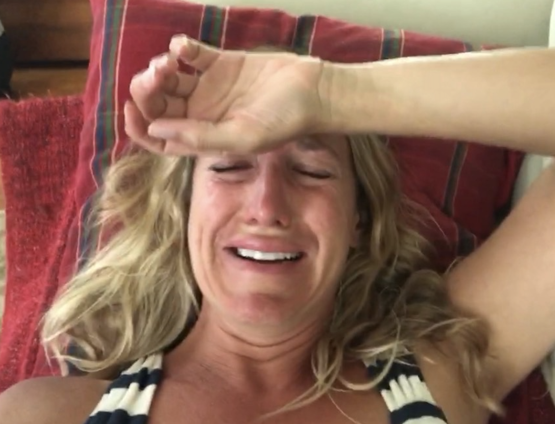 Kate West crying with her hand on her forehead