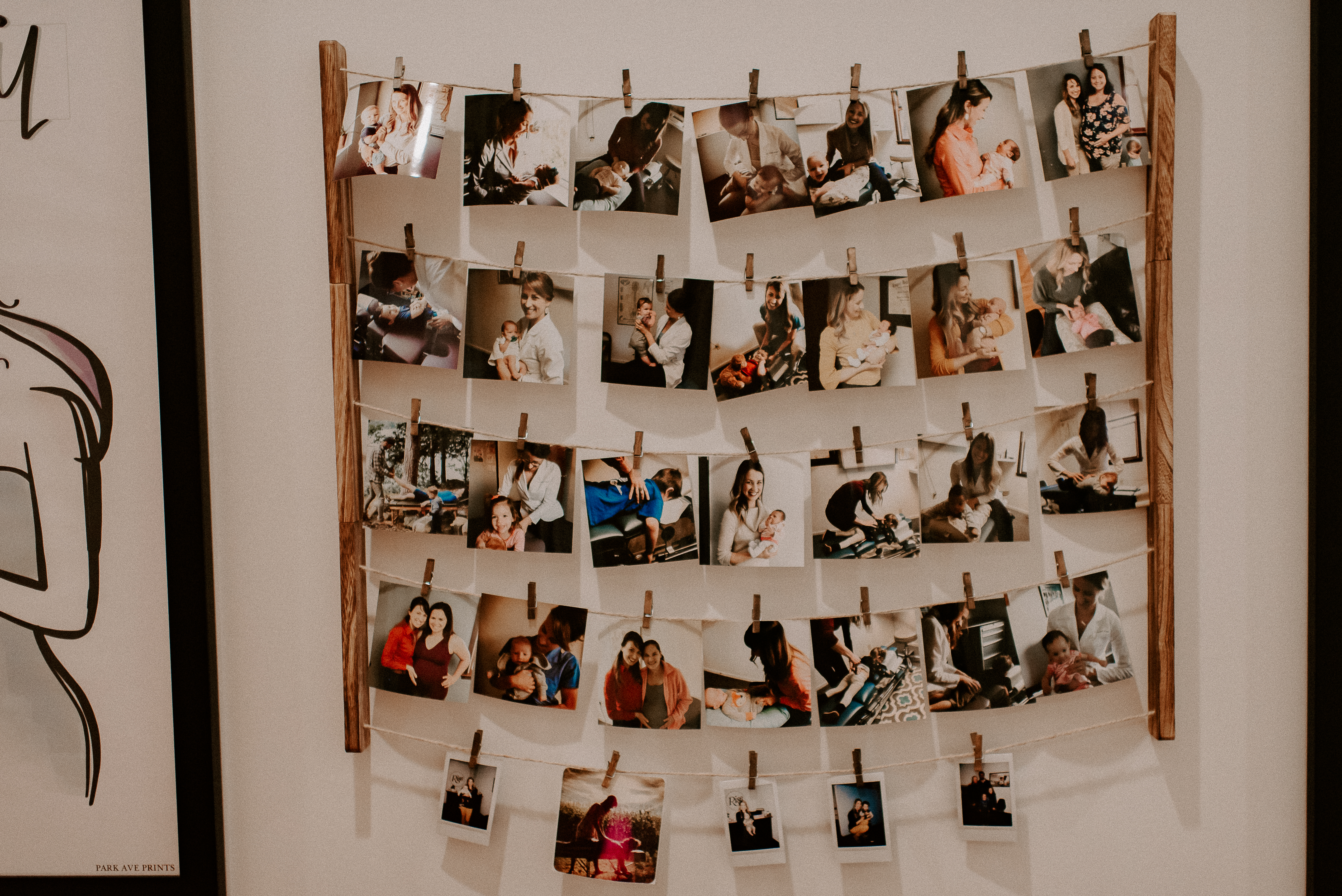 Hanging strings display with community patient photo cards at Rise Chiropractic