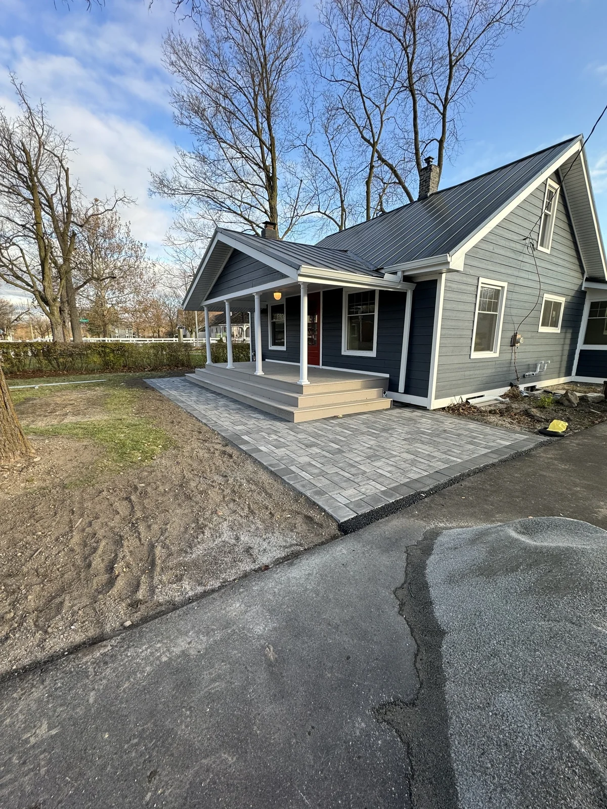 Brewers Homes project with blue siding, a covered porch and a paved patio