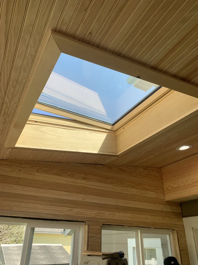Wood-lined interior with windows and a vaulted ceiling