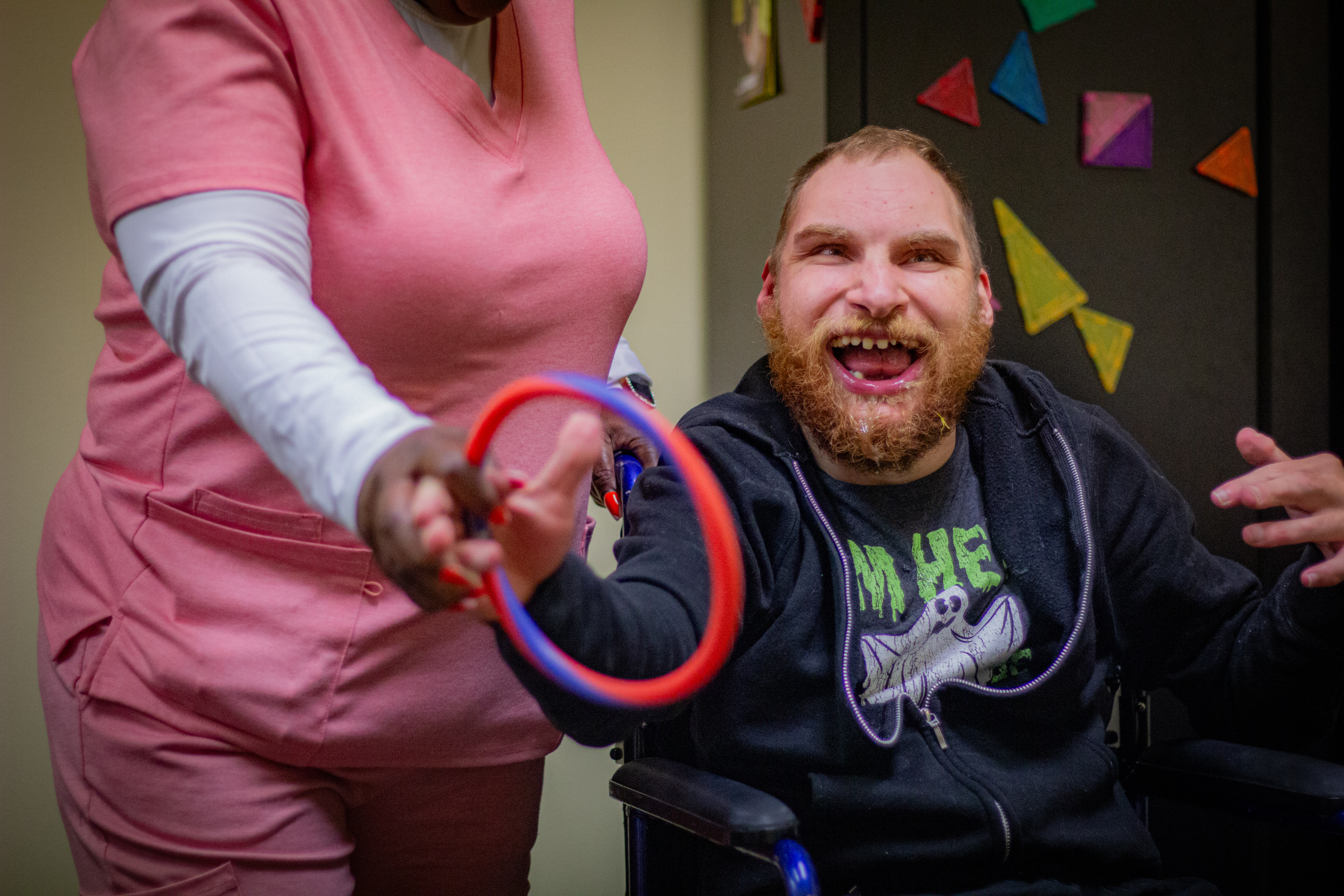 With the help of staff, a man tosses a ring during a game.