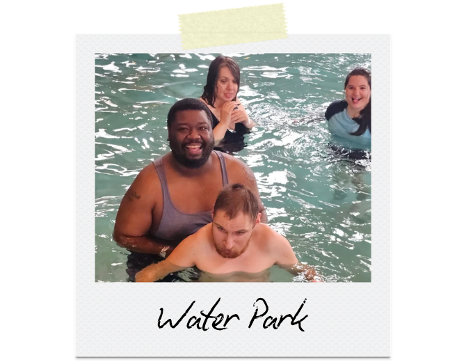 Water Park: With the help of staff, a participant is swimming at the water park.