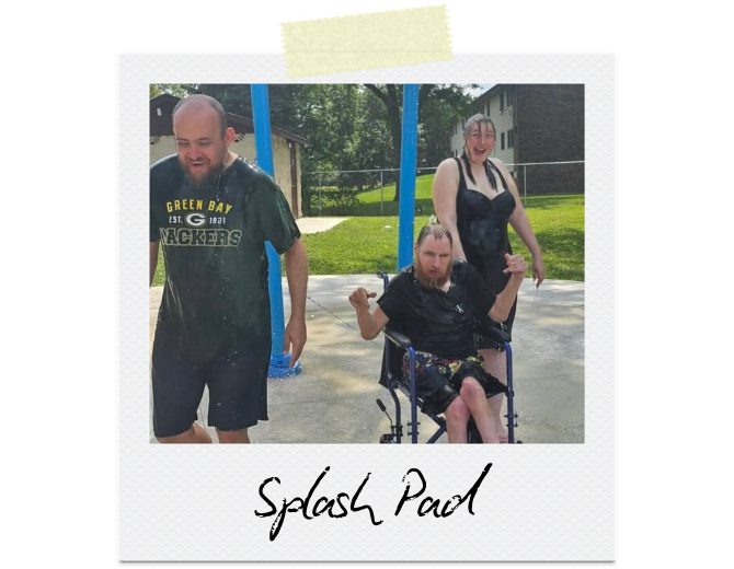 Three participants are enjoying the cool water on a splash pad.