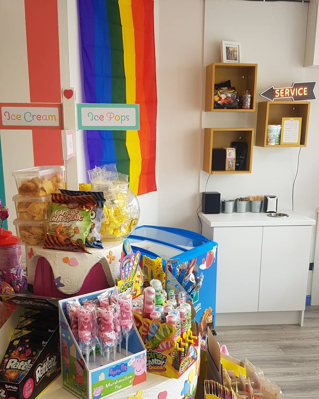 Colourful sweet display against the bright shop wall at Tiny's