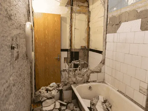 Interior room stripped down to the bare wooden studs during a renovation cleanup.