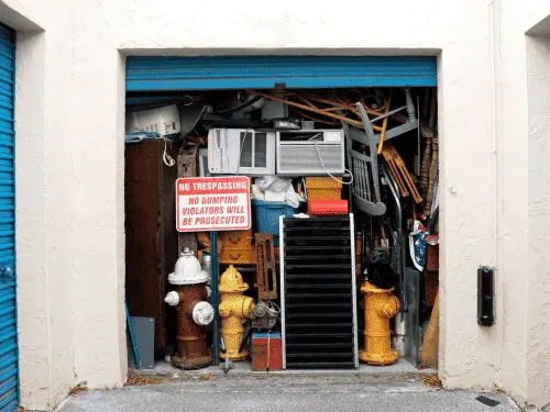 A packed commercial storage locker filled to the ceiling with old cardboard boxes.