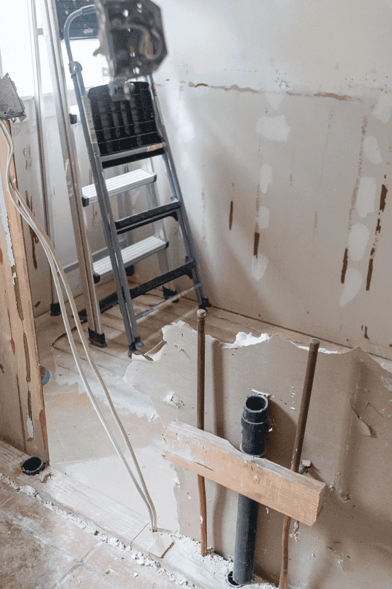 Exposed wooden floor joists and wall studs during a residential light demolition and remodeling project