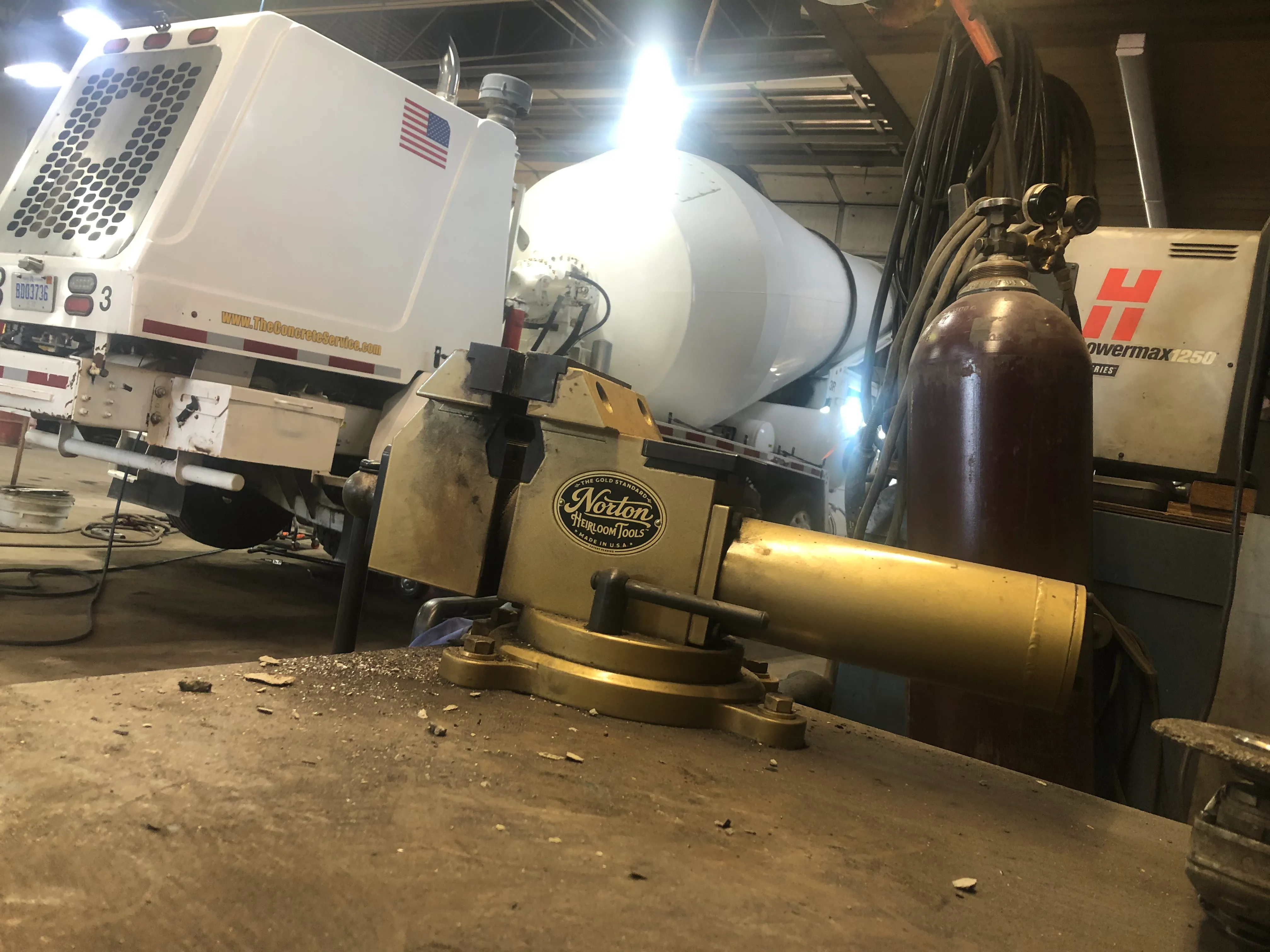 A Norton Model 60 vise on a welding bench at The Concrete Service, mixer truck behind it