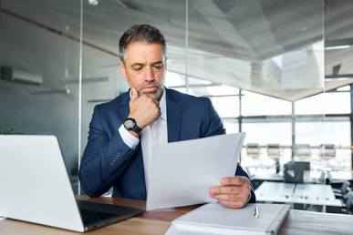 Business owner reviewing documents at her desk