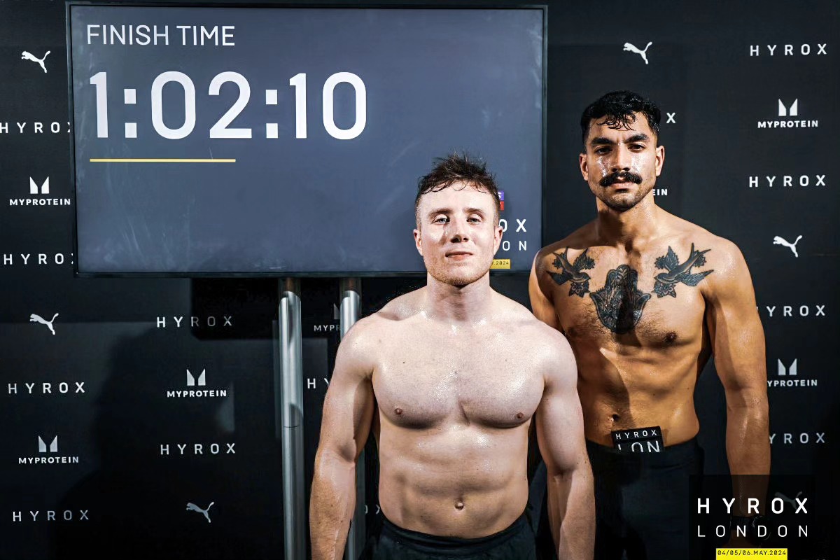 Mikey next to Hyrox finish time board