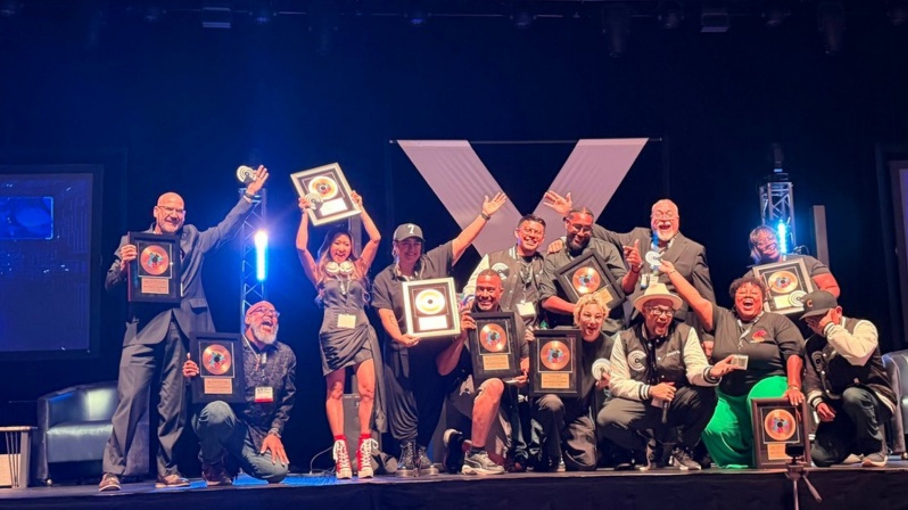 Pro DJ Certification 2026 graduating class on stage holding their graduation plaques