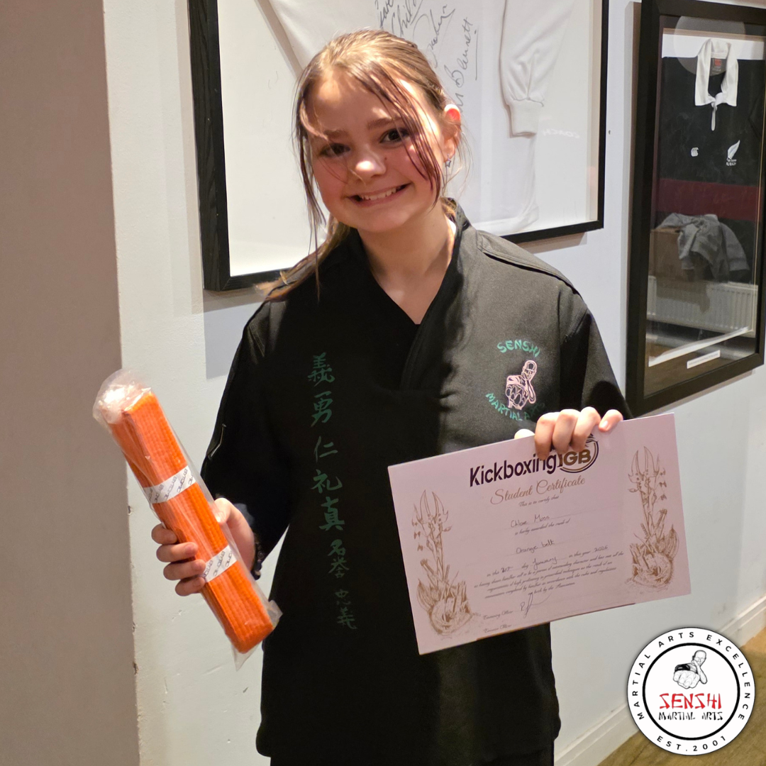 Sensh samurai kid smiling with her new grading belt and certificate