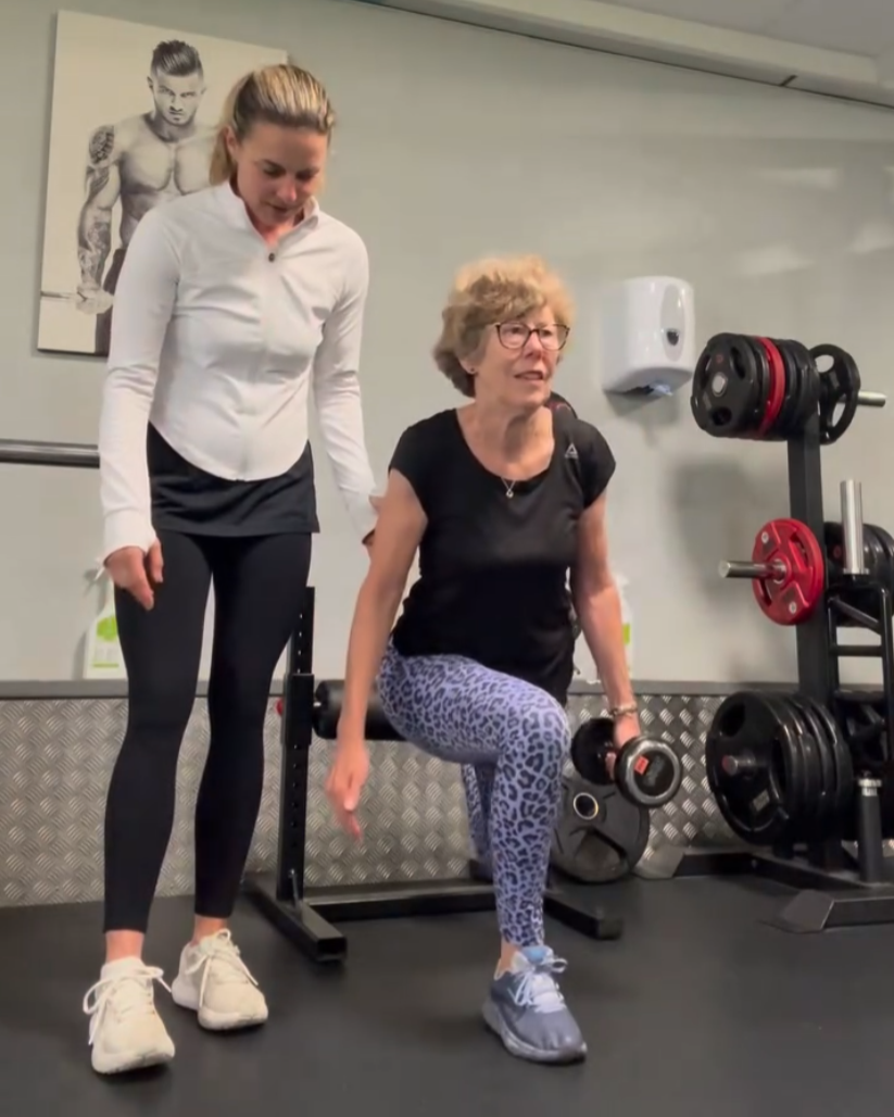 Kat celebrating a strength milestone with a client