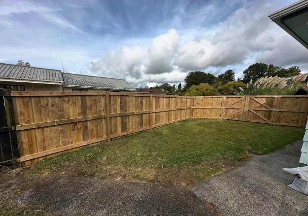 New wooden fence installation providing privacy and curb appeal for Northland home.