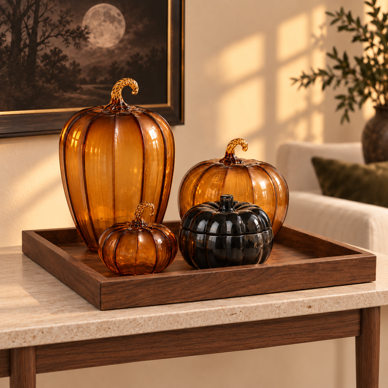 A grouping of amber glass pumpkins in several sizes on a console
