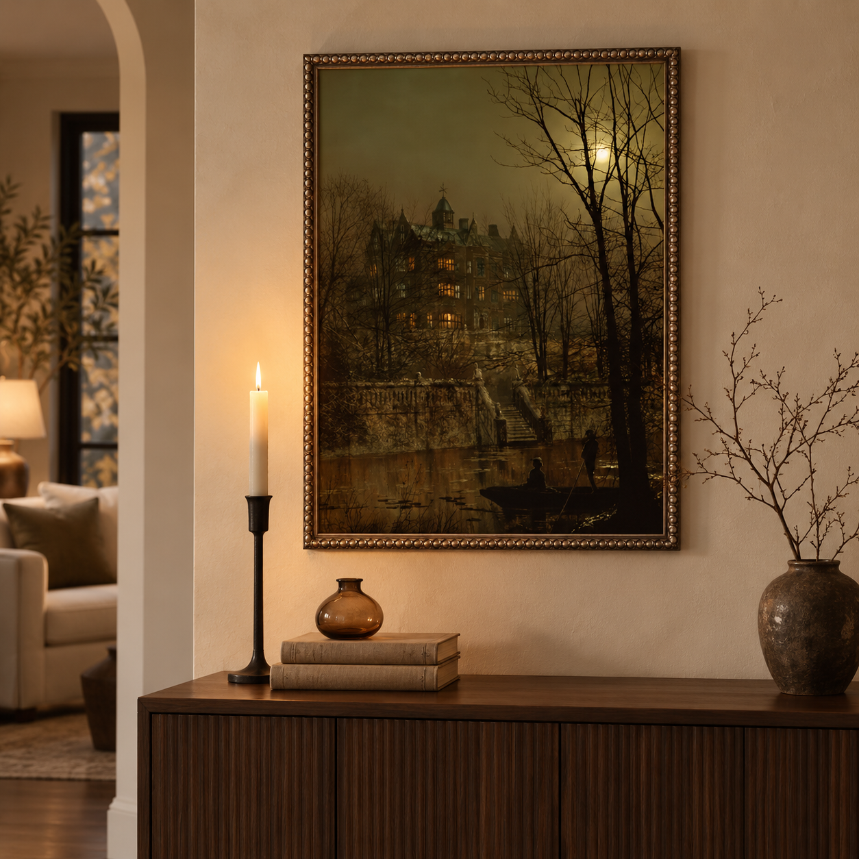 A moonlit old-world landscape painting leaning on a mantel with candles