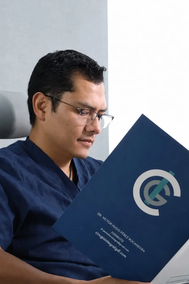 El Dr. Víctor Hugo Pérez Bocanegra revisa el expediente de un paciente en su consultorio