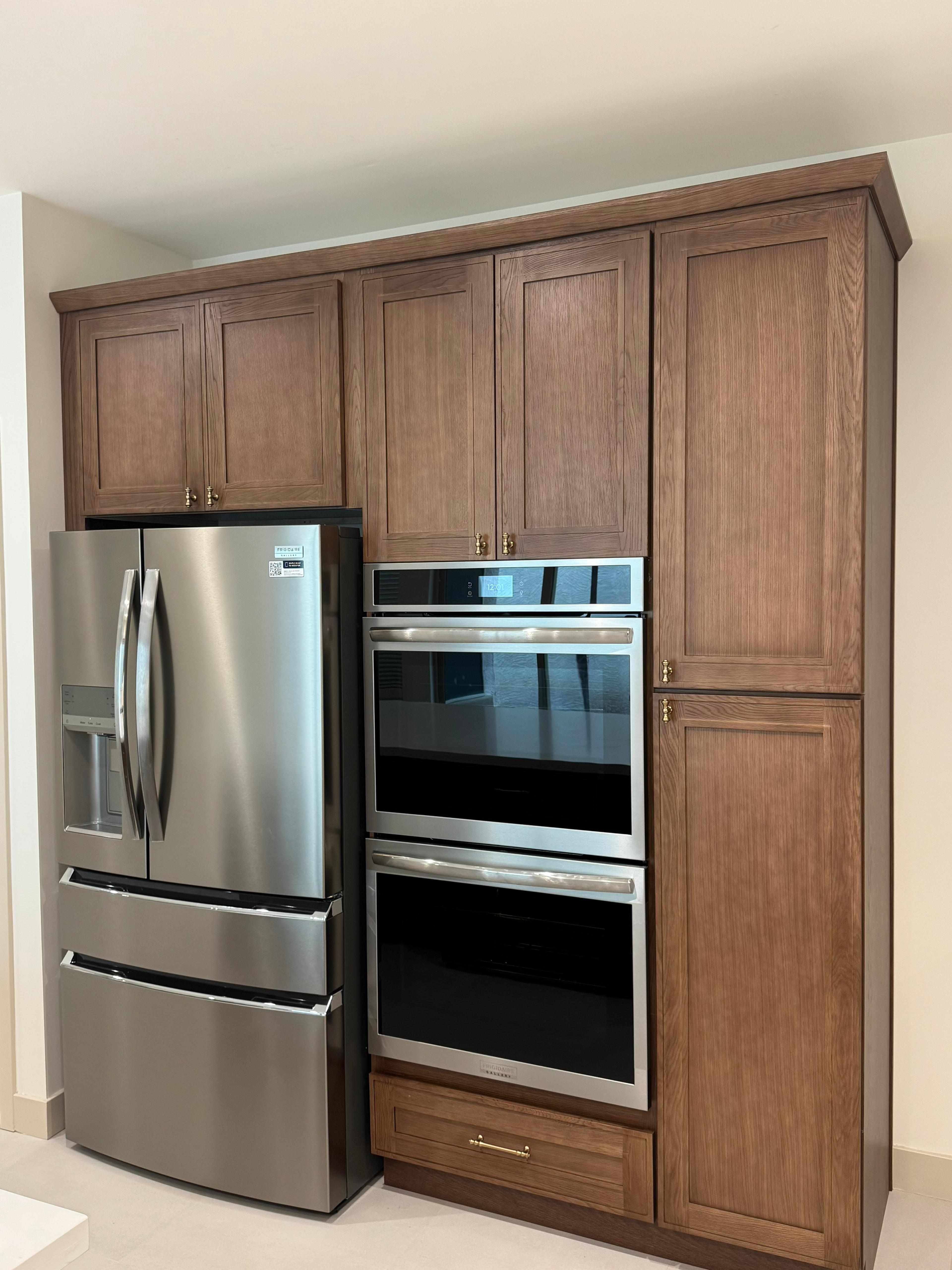 Custom kitchen cabinets with built in stainless steel refrigerator and double wall ovens