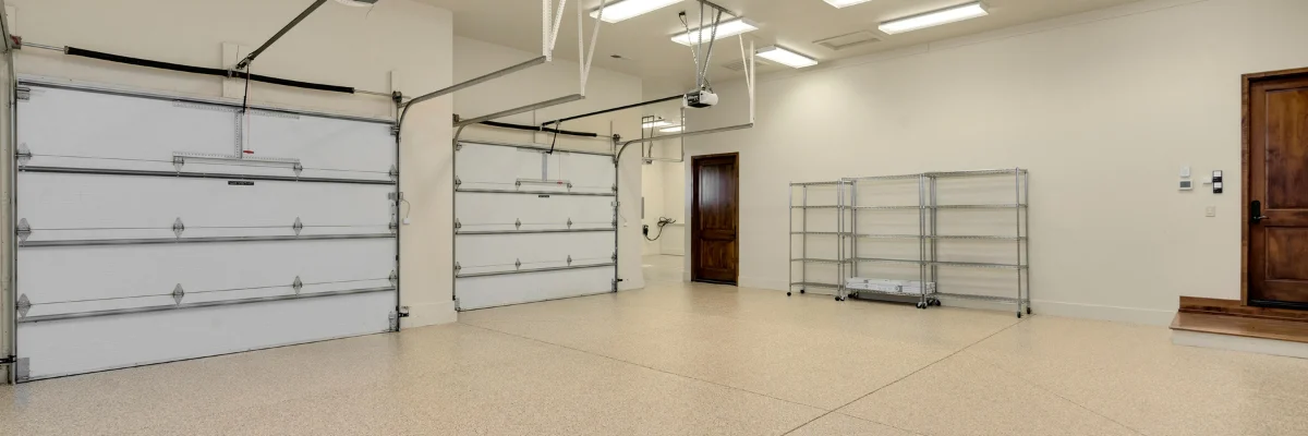 Spacious three-car garage with epoxy floor and storage racks. Spacious three-car garage with epoxy floor and storage racks.