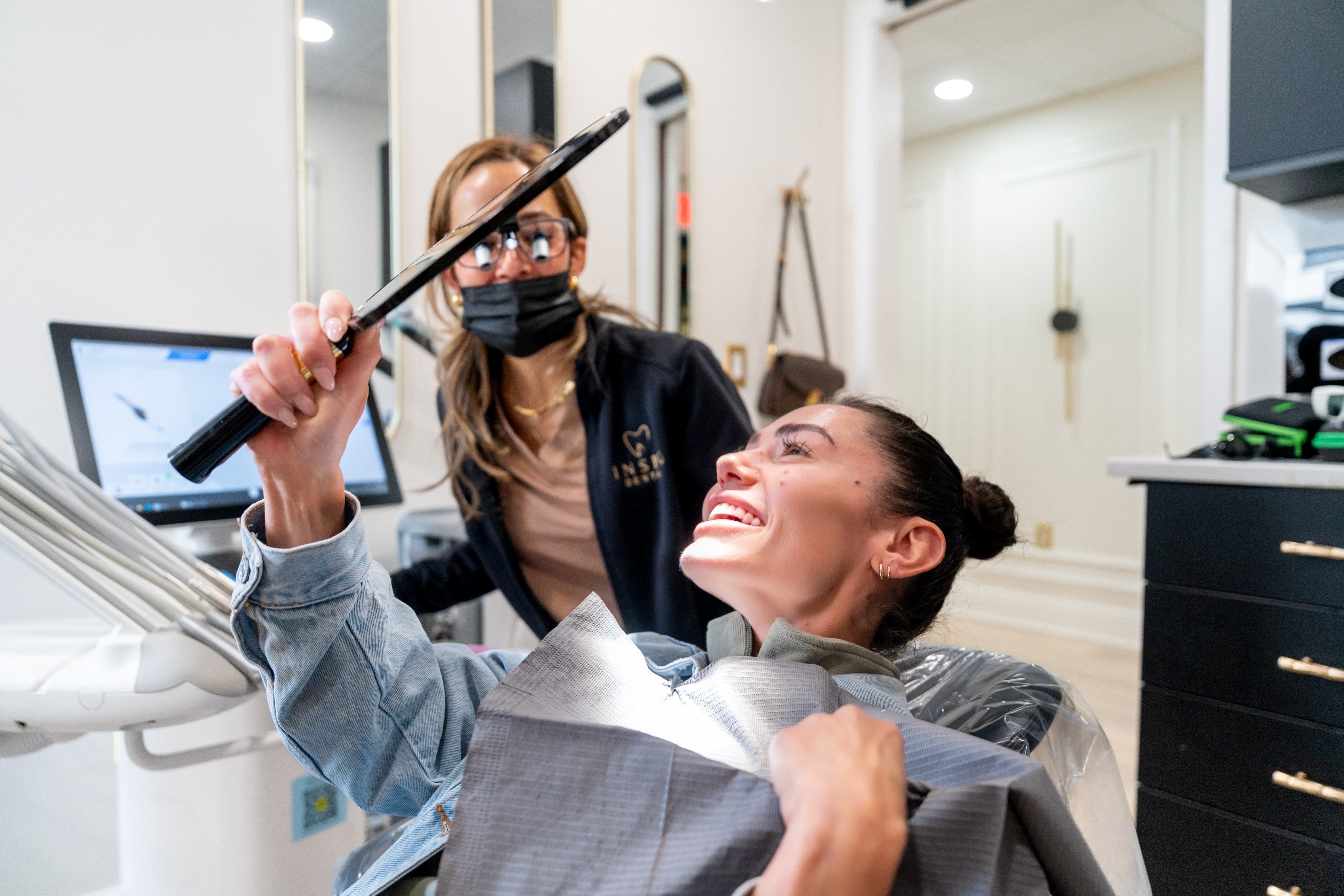 Team member with patient at Inspo Dental, smiling in a comfortable environment