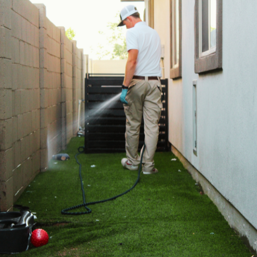 TC Dog Waste Removal technician applying a yard treatment during residential service