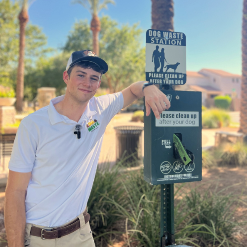 TC Dog Waste Removal team member beside a pet waste station at an Arizona community
