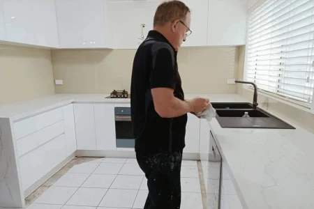 John installing glass splashback