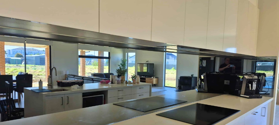 Modern mirror splashback installation in a Melbourne kitchen by Coloured Glass Solutions