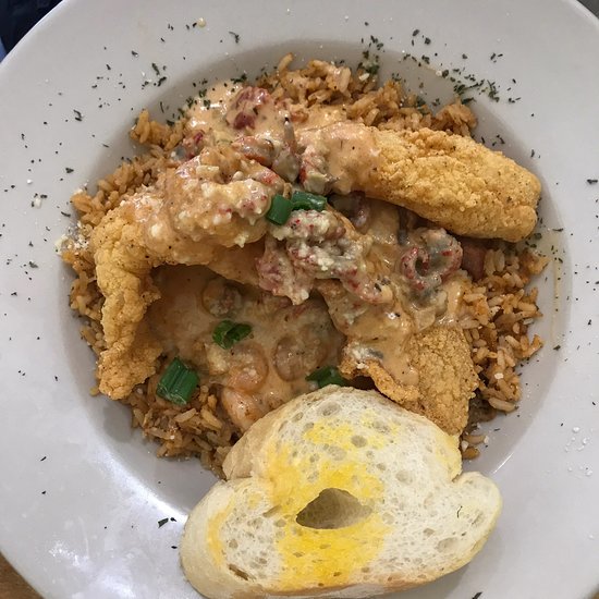 Fried fish over jambalaya with crawfish cream sauce and garlic bread at Bonnie C's Cafe in Slidell
