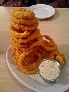 Tower of jumbo onion rings with dipping sauce at Bonnie C's Cafe