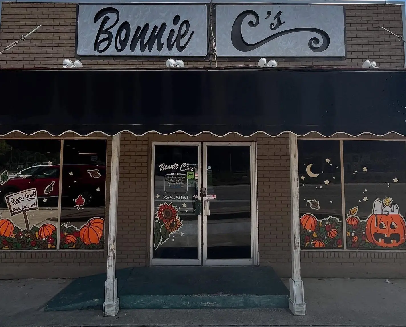 Bonnie C's Cafe storefront on Front Street in Slidell, LA, with fall paintings in the windows